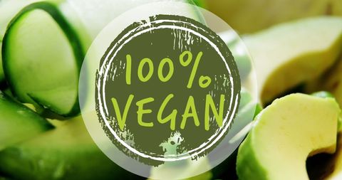 100% vegan label on fresh vegetable background