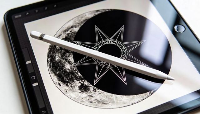 Digital tablet showing monochrome moon and geometric star illustration with white stylus and screen