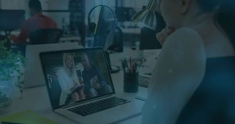 Remote meeting on laptop in modern office environment