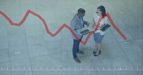 Colleagues Analyzing Financial Data with Chart Overlay