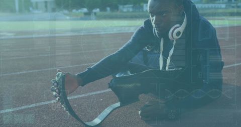Athlete with Leg Prosthetic Preparing for a Run Amidst Digital Overlay - Download Free Stock Images Pikwizard.com