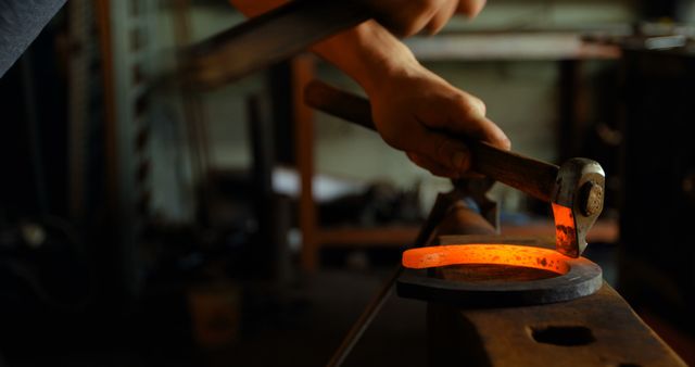 Blacksmith Shaping Hot Metal with Hammer and Tongs in Workshop - Download Free Stock Images Pikwizard.com