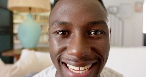 Joyful Man Grinning in Cozy Living Room setting