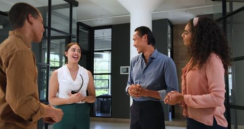 Diverse team celebrating success with happy conversation