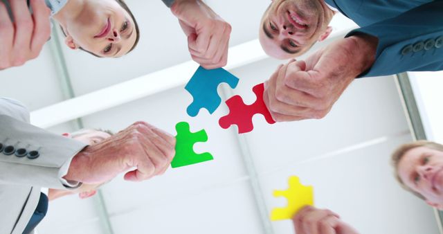 Image of business people holding piece of puzzle 