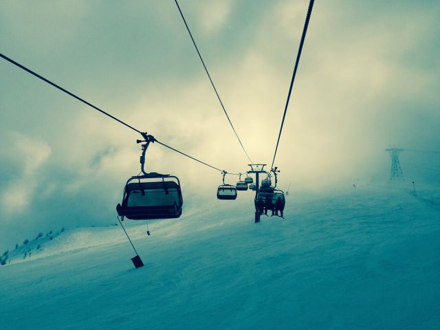 Ski Lift Chairs Rising Above Snowy Mountain in Foggy Weather - Download Free Stock Photos Pikwizard.com