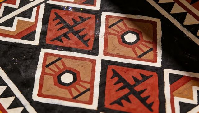 Hand-painted geometric pattern featuring rust red and tan squares grid tessellation