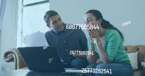 Couple Analyzing Financial Data on Laptop