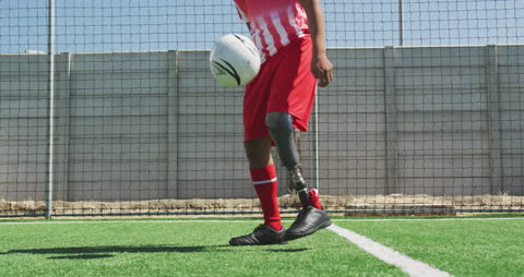 Inclusive Sports: Soccer Player with Prosthetic Leg Practicing