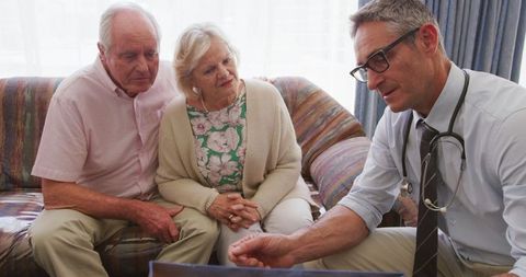 Doctor Discussing X-ray with Senior Couple at Home