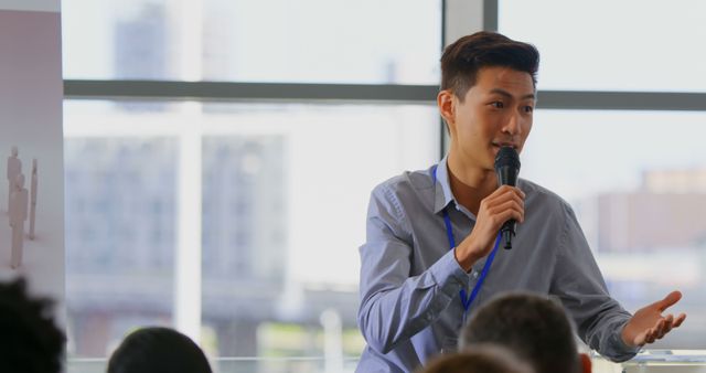 Front view of an Asian male speaker speaking and standing on the podium in the business seminar 4k