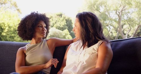 Mother and Daughter Enjoying Outdoor Conversation on Couch