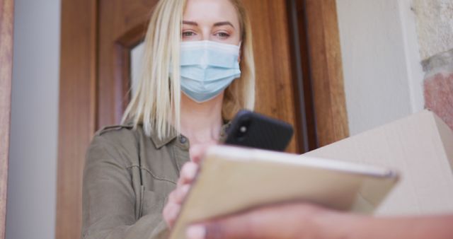 Woman Receiving Package Delivery Wearing Face Mask - Download Free Stock Images Pikwizard.com