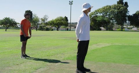 Indian bowler preparing run-up while umpire watching and batsman taking guard on field