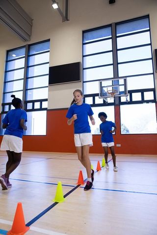 Students Running Agility Drill in School Gym