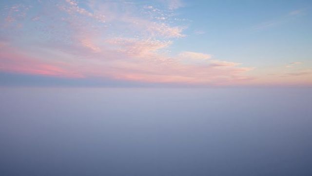 Tranquil aerial view of clouds under pastel sky at dusk