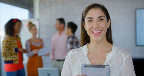Cheerful Businesswoman Holding Tablet in Office Environment - Download Free Stock Images Pikwizard.com