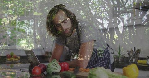 Chef Chopping Fresh Vegetables in Modern Kitchen with Tablet