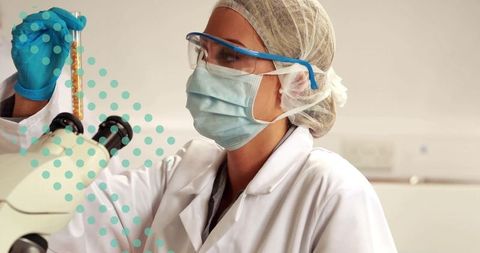 Scientist Analyzing Sample Beside Microscope in Laboratory