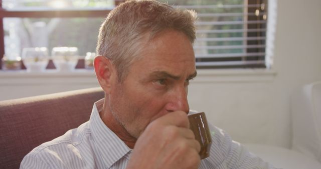 Mature Man Drinking Coffee in Relaxing Home Interior - Download Free Stock Images Pikwizard.com