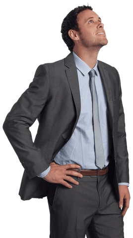 Smiling young businessman looking up with confidence