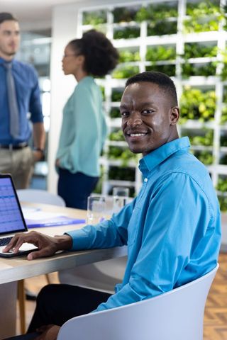 Smiling african american professional in modern green office