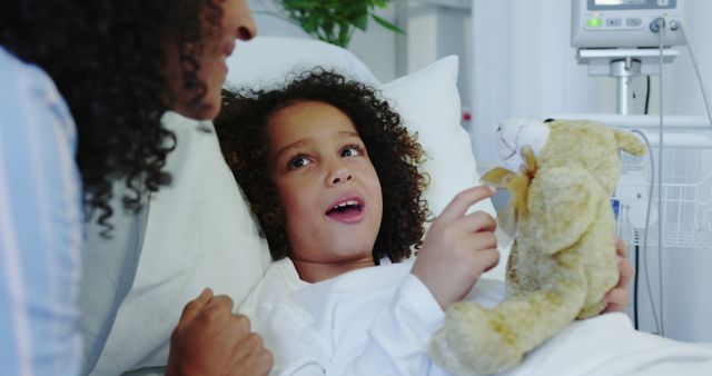 Caring Mother Comforting Child Holding Teddy Bear in Hospital Bed - Download Free Stock Images Pikwizard.com