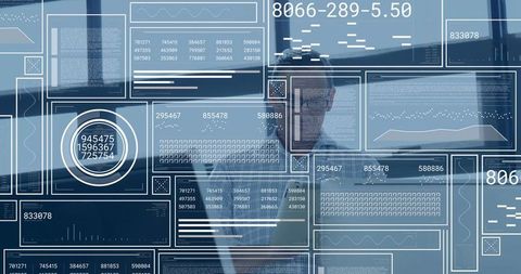 Business analyst analyzing interactive data dashboards through glass hud interface in modern office