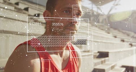 Mid-adult male athlete training with augmented reality hud overlay on stadium bleachers