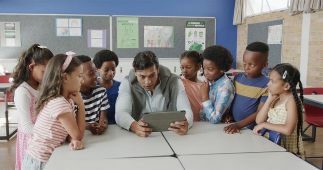 Teacher using tablet during class with attentive diverse students - Download Free Stock Images Pikwizard.com