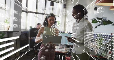Business team collaborating on tablet with holographic data dashboards in modern coworking