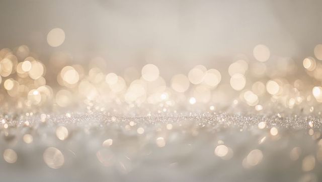 Golden bokeh glitter background with soft sparkling texture and warm light reflections