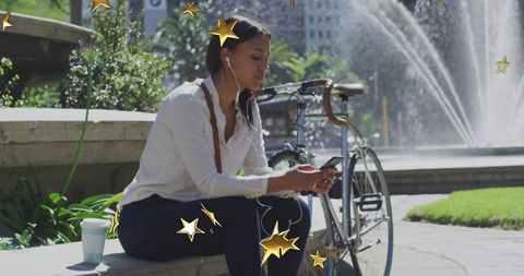 Woman relaxing at fountain plaza using smartphone