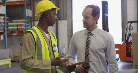 Warehouse Worker and Manager Collaborating on Logistics - Download Free Stock Images Pikwizard.com