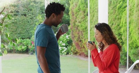 Happy Couple Enjoying Coffee on Patio Relaxing Outdoors