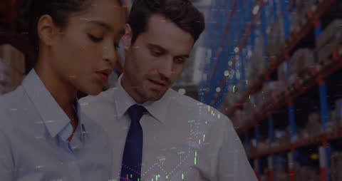 Warehouse Workers Analyzing Financial Graphs in Storage Facility