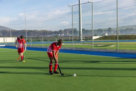 Male Hockey Players Engaged in Active Outdoor Game