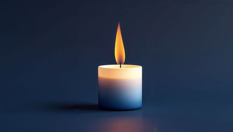Candle Burning Tranquilly on Dark Surface with Blue Hue