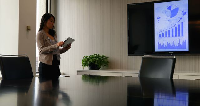 Businesswoman Analyzing Digital Tablet in Modern Conference Room - Download Free Stock Images Pikwizard.com
