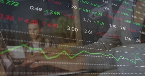 Hands typing trading data on laptop with finance overlay