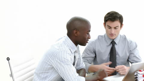 Two Businessmen Collaborating with Laptop in Office