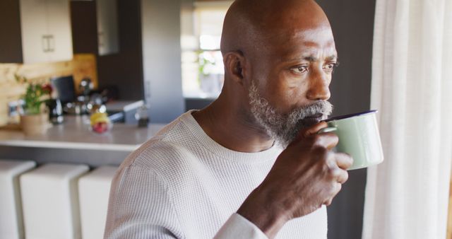 Senior man drinking morning coffee in kitchen - Download Free Stock Images Pikwizard.com