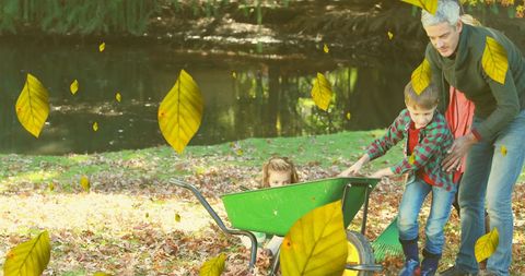 Family fun in autumn with children playing in leaves