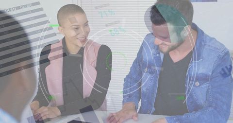 Diverse colleagues brainstorming with futuristic data overlay