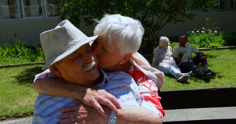 Senior couple embracing in nursing home garden