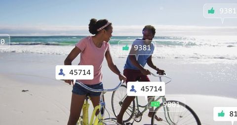 Couple cycling along sunny shoreline showing social media likes and followers
