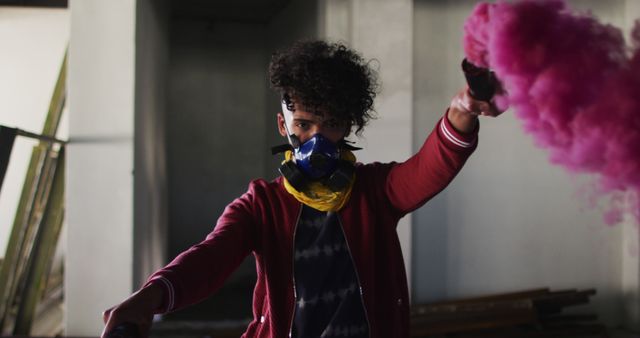 This image depicts an urban explorer in an abandoned building, holding pink smoke flares while wearing a respirator. Ideal for themes related to adventure, urban exploration, mystery, street art, protective gear, and exploring abandoned places.
