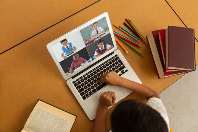 Biracial boy using laptop for video call, with diverse elementary school pupils on screen - Download Free Stock Photos Pikwizard.com
