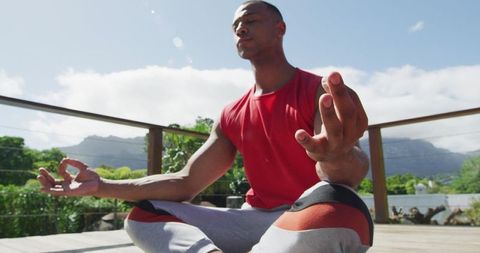Calm Young Man Practicing Outdoor Meditation on Sunny Day