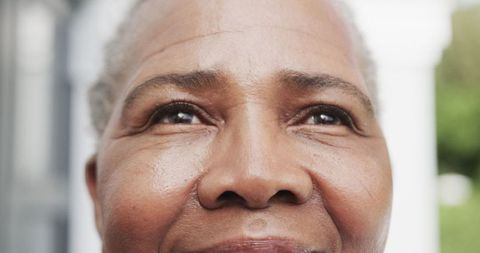 Close-up portrait of smiling senior african american woman outdoors